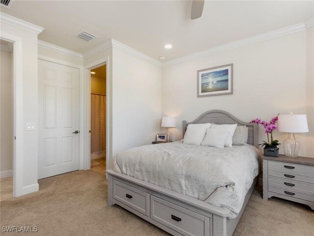 bedroom with ornamental molding, light carpet, and ceiling fan