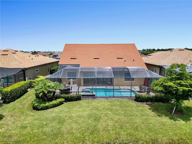 back of property featuring a lanai, a patio area, and a lawn