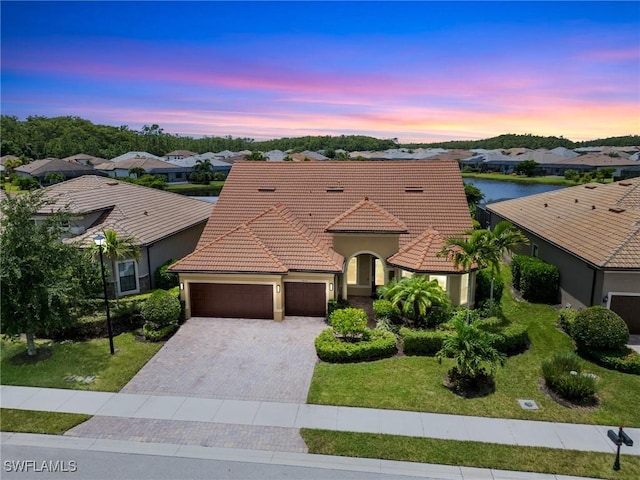 view of front of house featuring a garage and a yard