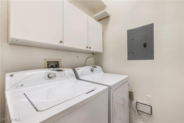 clothes washing area featuring electric panel, cabinet space, and washing machine and clothes dryer