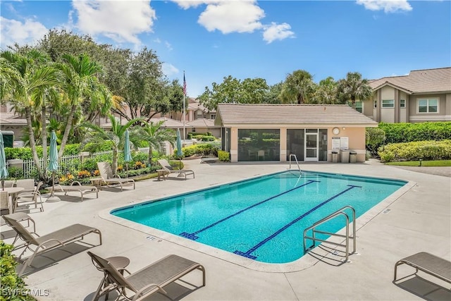 community pool featuring a patio and fence