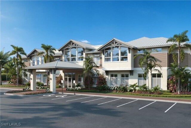 view of front of property featuring uncovered parking and stucco siding