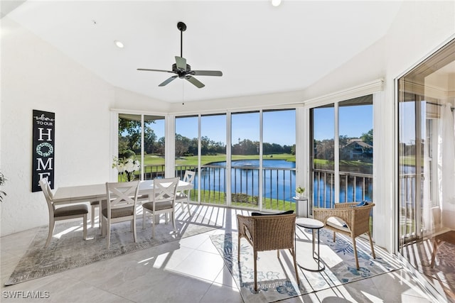 sunroom with lofted ceiling, a water view, and ceiling fan