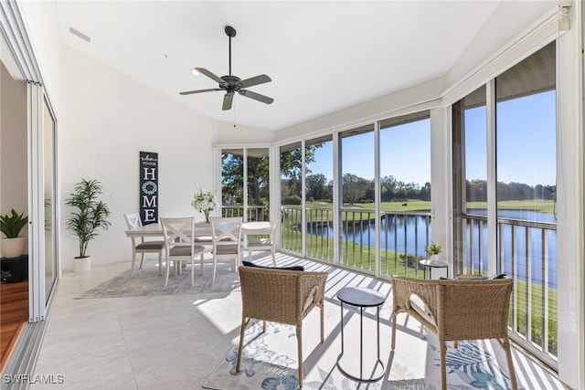 sunroom featuring a ceiling fan, lofted ceiling, visible vents, and a water view