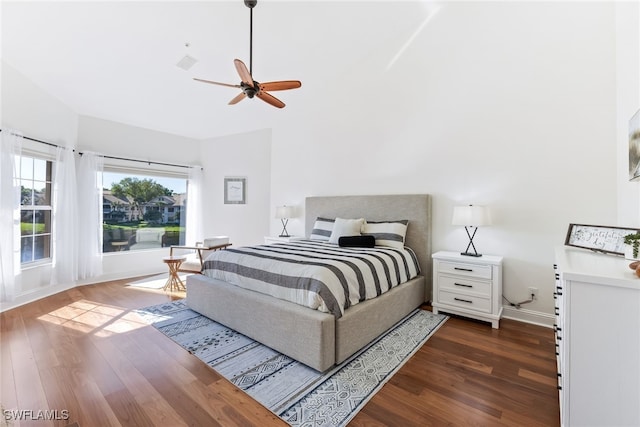 bedroom featuring visible vents, wood finished floors, baseboards, and ceiling fan