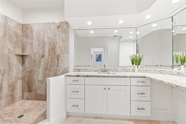 bathroom featuring vanity, recessed lighting, and tiled shower