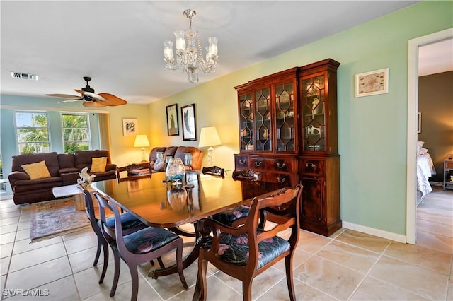 dining room featuring light tile patterned floors and ceiling fan with notable chandelier