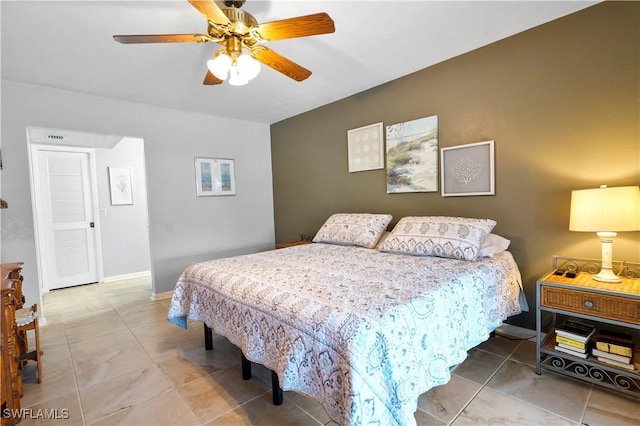 tiled bedroom with ceiling fan