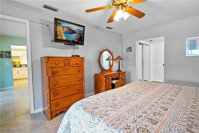 tiled bedroom with ceiling fan