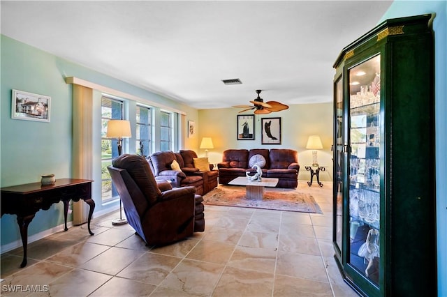 tiled living room featuring ceiling fan