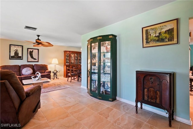 tiled living room featuring ceiling fan