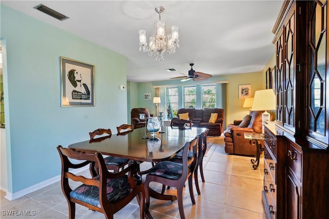 tiled dining area featuring ceiling fan with notable chandelier