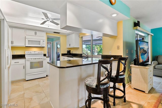 kitchen featuring kitchen peninsula, white appliances, ceiling fan, sink, and white cabinetry