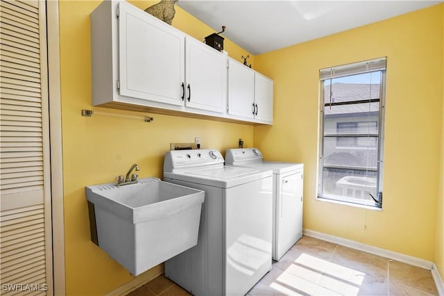 laundry room featuring cabinets, independent washer and dryer, sink, and light tile patterned floors