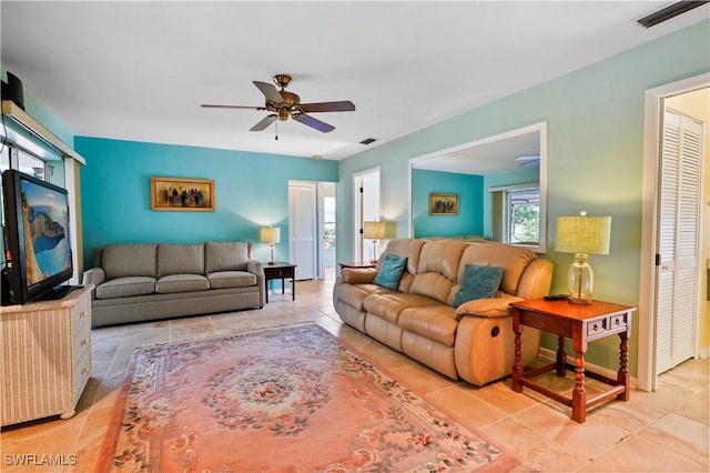 living room with ceiling fan and light tile patterned flooring