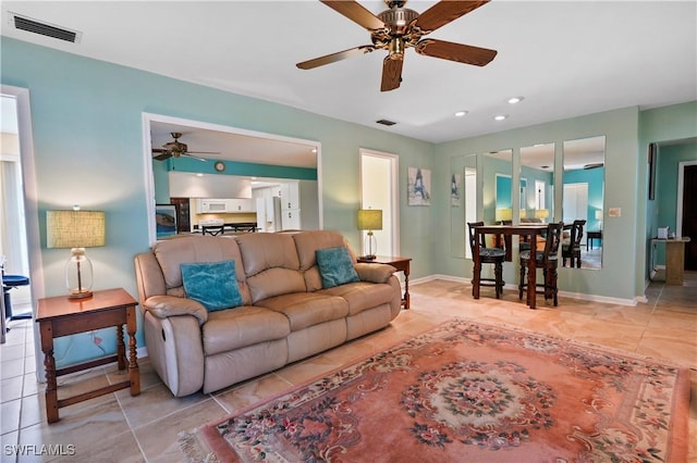 tiled living room featuring ceiling fan