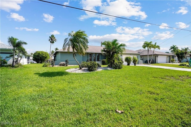 ranch-style home with a garage and a front lawn