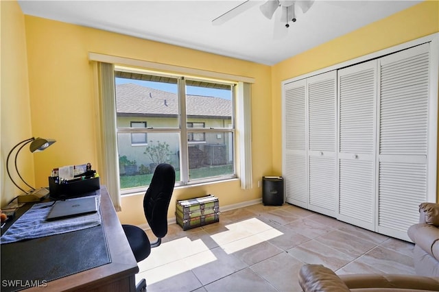 tiled office space featuring ceiling fan and plenty of natural light