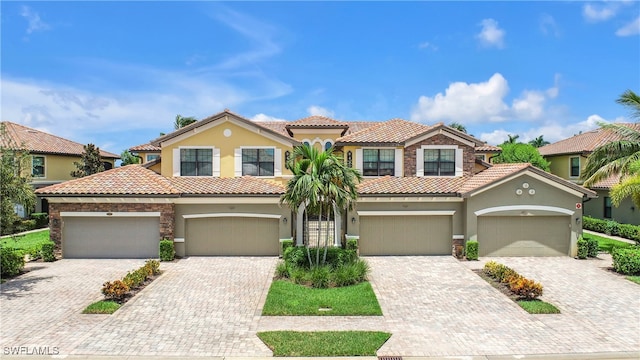 mediterranean / spanish-style house with a garage