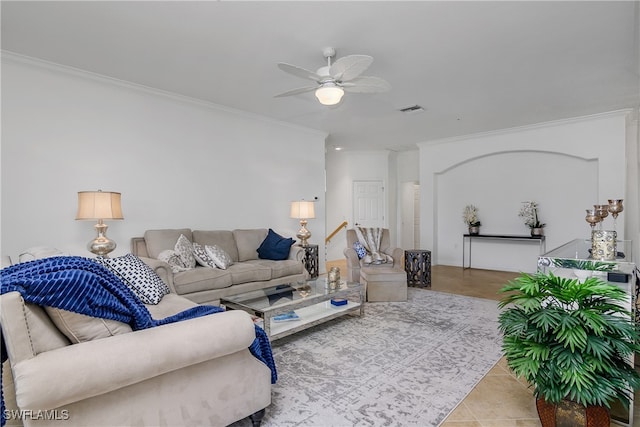 tiled living room with crown molding and ceiling fan