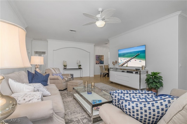 living room with crown molding, ceiling fan, and light tile patterned flooring