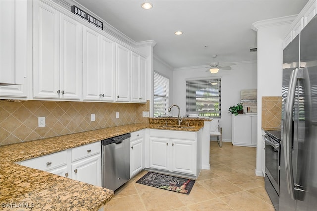 kitchen with sink, appliances with stainless steel finishes, kitchen peninsula, light stone countertops, and white cabinets