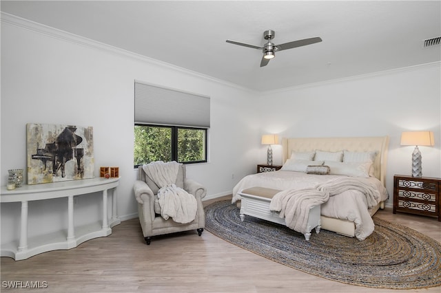 bedroom with wood-type flooring, ornamental molding, and ceiling fan