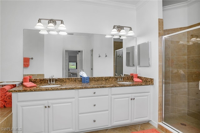 bathroom featuring a shower with door, crown molding, vanity, and tile patterned floors