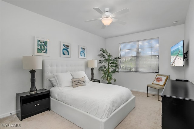 bedroom featuring light colored carpet and ceiling fan