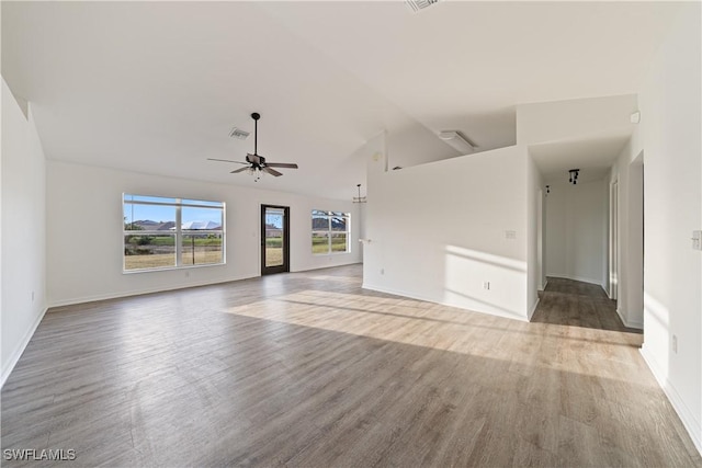 unfurnished living room with wood-type flooring, lofted ceiling, and ceiling fan