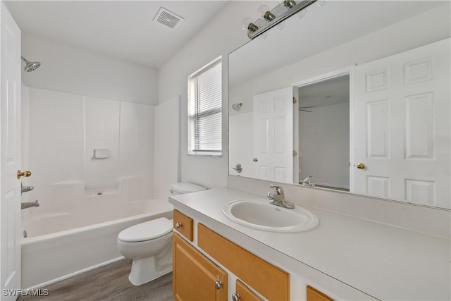 full bathroom featuring vanity, toilet, tub / shower combination, and hardwood / wood-style floors