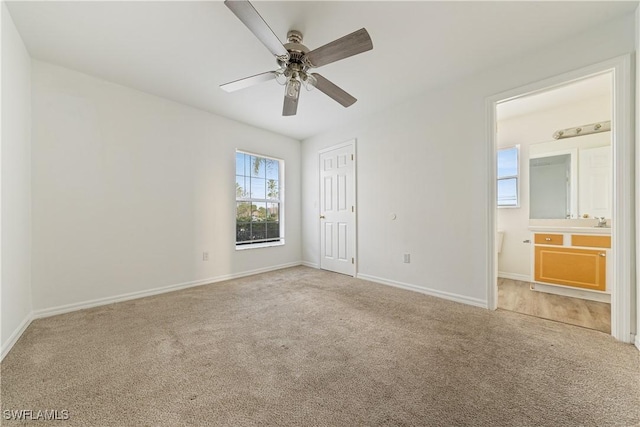 unfurnished bedroom featuring carpet floors, connected bathroom, ceiling fan, and a closet