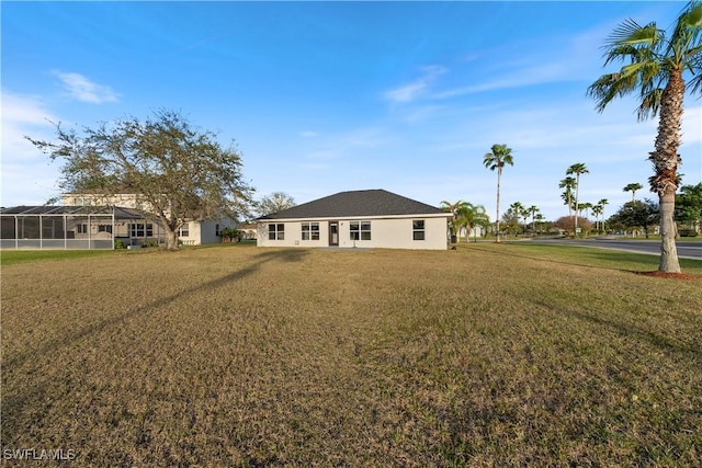 back of property featuring a lawn