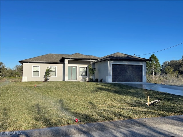 view of front of property with a front yard and a garage