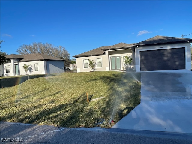 view of front of house featuring a front lawn and a garage