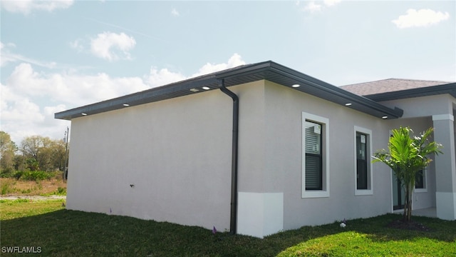 view of side of property with a lawn