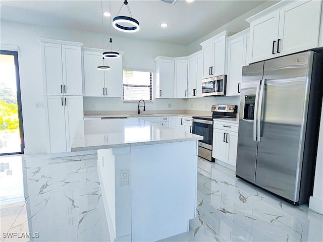 kitchen with decorative light fixtures, white cabinetry, light tile patterned floors, and stainless steel appliances