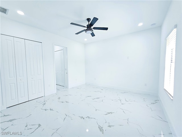 unfurnished bedroom with multiple windows, tile patterned flooring, and ceiling fan