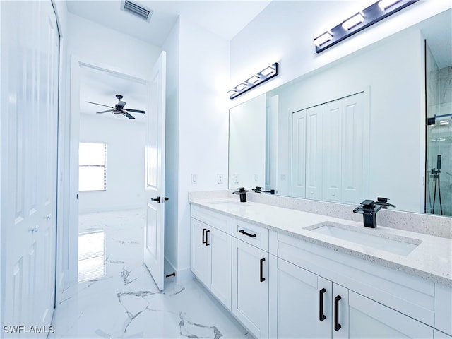 bathroom with tile patterned flooring, ceiling fan, and double sink vanity