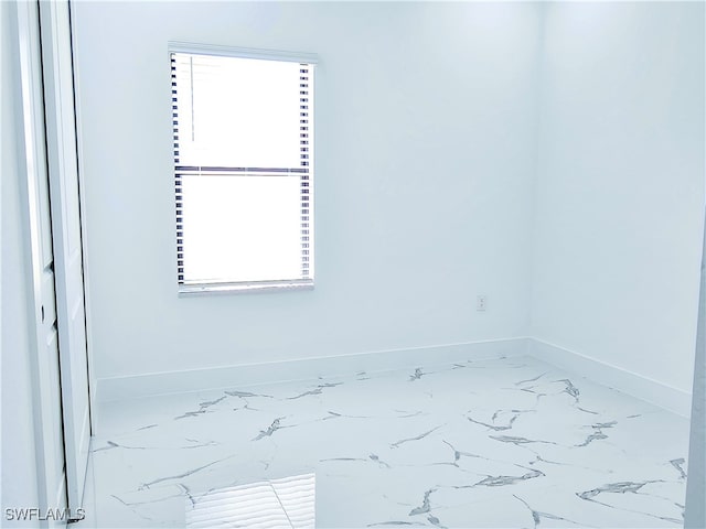 unfurnished room featuring a wealth of natural light and tile patterned floors