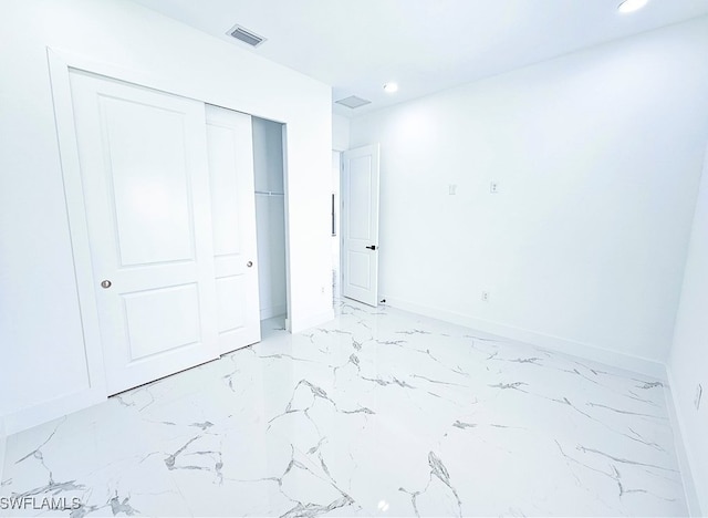 tiled bedroom with a closet