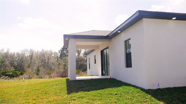 view of side of home featuring a yard