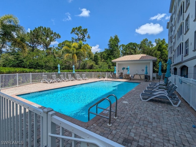 view of swimming pool featuring a patio area