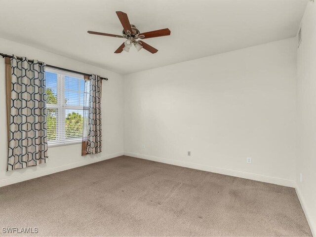 carpeted spare room with ceiling fan