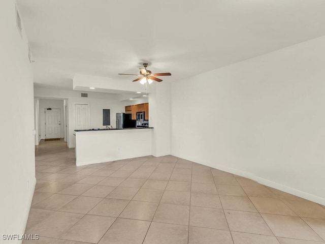 unfurnished living room with light tile patterned floors and ceiling fan