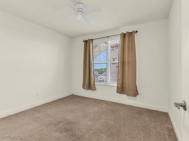 spare room with carpet floors and ceiling fan