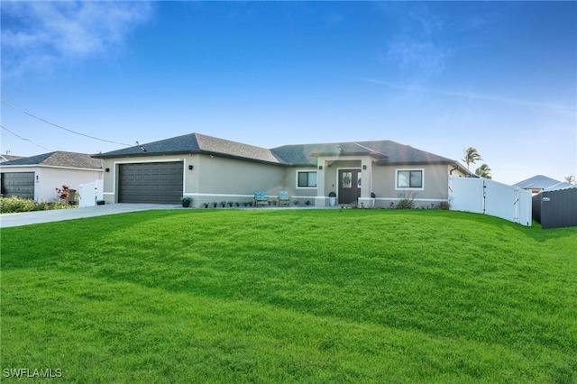 view of front of home with a garage and a front lawn