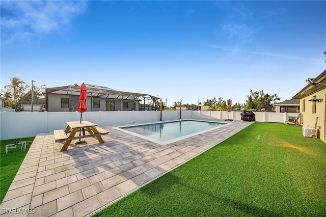 view of pool with a patio, a lanai, and a lawn