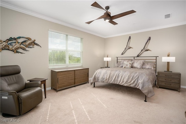 carpeted bedroom with ceiling fan and ornamental molding