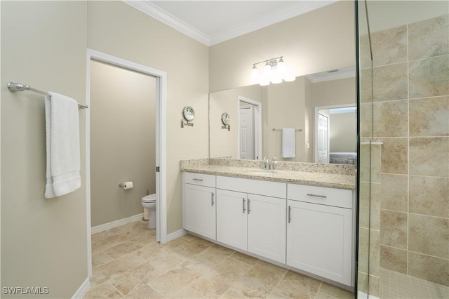 full bath with crown molding, toilet, a tile shower, vanity, and baseboards